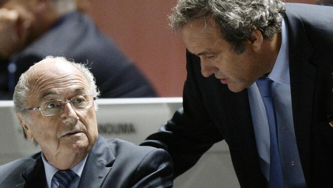 FILE - FIFA President Sepp Blatter, left, and UEFA President Michel Platini are engaged in conversation during the 65th FIFA Congress held at the Hallenstadion in Zurich, Switzerland, on Friday, May 29, 2015. Swiss prosecutors have charged former FIFA officials Sepp Blatter and Michel Platini with fraud and other offenses. (Walter Bieri/Keystone via AP)