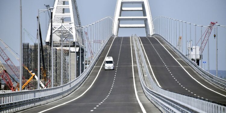 A vehicle runs down the 19 km road-and-rail Crimean Bridge passing over the Kerch Strait and linking southern Russia to the Crimean peninsula on May 15, 2018, in Kerch, prior to the opening ceremony.
Russian President, on May 15 is set to unveil a 19-kilometre-long bridge linking southern Russia to the Crimean peninsula annexed from Ukraine, a highly symbolic project he has personally championed. Built at a cost of 228 billion rubles ($3.69 billion), the new structure connects the southern Krasnodar region with the Crimean city of Kerch, spanning a strait between the Black Sea and the Azov Sea. / AFP PHOTO / POOL / Alexander NEMENOV