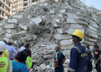 Emergency personnel stands by the debris of the collapsed building in Ikoyi, Lagos, Nigeria, November 1, 2021. Picture taken November 1, 2021. REUTERS/Nneka Chile