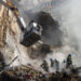 Firefighters work after a drone fired on buildings in Kyiv, Ukraine, Monday, Oct. 17, 2022. Waves of explosive-laden suicide drones struck Ukraine's capital as families were preparing to start their week early Monday, the blasts echoing across Kyiv, setting buildings ablaze and sending people scurrying to shelters. (AP Photo/Roman Hrytsyna)