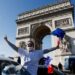 Protesters wave French flags on the Champs-Elysees avenue as cars parade during their "Convoi de la liberte" (The Freedom Convoy), a vehicular convoy to protest coronavirus disease (COVID-19) vaccine and restrictions in Paris, France, February 12, 2022. REUTERS/Benoit Tessier