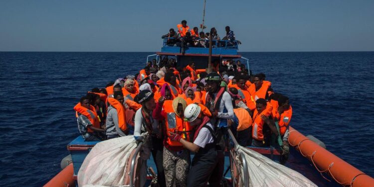 Migrants are rescued by members of the Aquarius rescue ship run by non-governmental organisations (NGO) "SOS Mediterranee" and "Medecins Sans Frontieres" (Doctors Without Borders) in the Mediterranean Sea, 30 nautic miles from the Libyan coast, on August 2, 2017. Italy on August 2, 2017 began enforcing a controversial code of conduct for charity boats rescuing migrants in the Mediterranean as new figures revealed a sharp drop in the numbers of people arriving from Libya. / AFP PHOTO / Angelos Tzortzinis ITALY-LIBYA-EUROPE-MIGRANTS-NGO