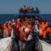 Migrants are rescued by members of the Aquarius rescue ship run by non-governmental organisations (NGO) "SOS Mediterranee" and "Medecins Sans Frontieres" (Doctors Without Borders) in the Mediterranean Sea, 30 nautic miles from the Libyan coast, on August 2, 2017. Italy on August 2, 2017 began enforcing a controversial code of conduct for charity boats rescuing migrants in the Mediterranean as new figures revealed a sharp drop in the numbers of people arriving from Libya. / AFP PHOTO / Angelos Tzortzinis ITALY-LIBYA-EUROPE-MIGRANTS-NGO