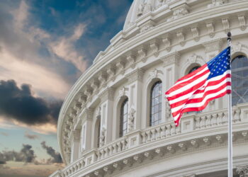 Washington DC Capitol dome detail with waving american flag