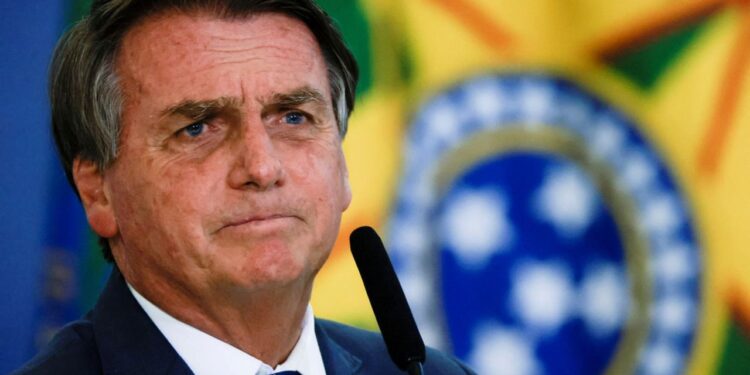 Brazil's President Jair Bolsonaro looks on during the launch ceremony of the National Identity Card at the Planalto Palace in Brasilia, Brazil February 23, 2022. REUTERS/Ueslei Marcelino