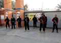 Police officers stand guard outside a polling station in Gulbahar area in Peshawar, Pakistan, February 8, 2024. REUTERS/Fayaz Aziz