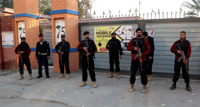 Police officers stand guard outside a polling station in Gulbahar area in Peshawar, Pakistan, February 8, 2024. REUTERS/Fayaz Aziz